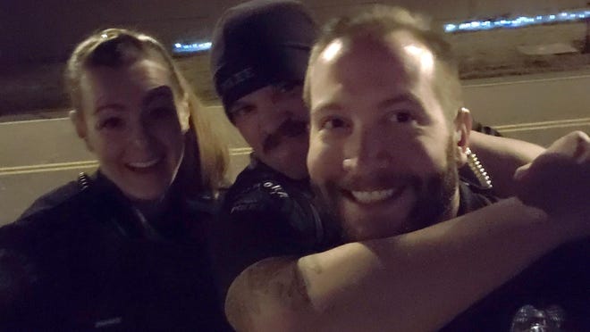 FILE - This photo released by the Aurora Police Department, in Colorado, shows Officers Erica Marrero, from left, Jaron Jones and Kyle Dittrich. Dittrich and Marrero who were fired for the photo reenacting a chokehold used on a Black man arrested in August have filed appeals of their terminations, the Aurora Civil Service Commission said Thursday, July 9, 2020.