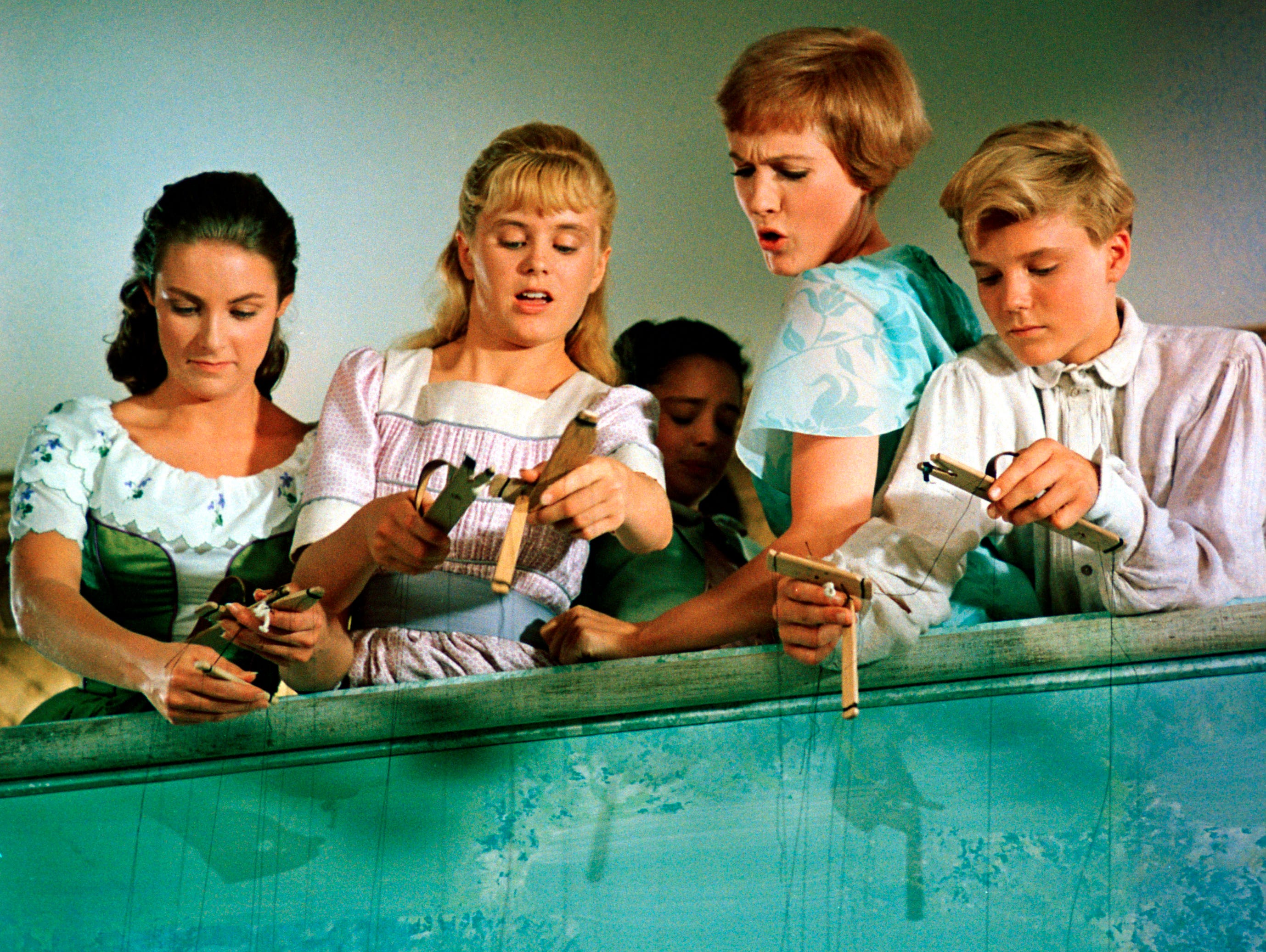 Heather Menzies (second from left), played one of the von Trapp sisters in the Oscar-winning 1965 film 'The Sound of Music,' alongside Chairmian Carr as Liesl (left), Julie Andrews as Maria, and Nicholas Hammond as Friedrich, in a scene with puppets 