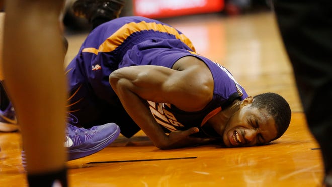 Phoenix Suns guard Brandon Knight goes down with an injury against the Golden State Warriors during the second quarter at US Airways Center in Phoenix, Ariz. March 9, 2015.