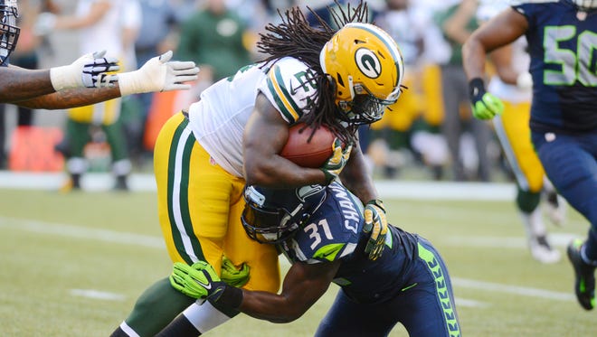 Green Bay Packers running back Eddie Lacy gets stopped for no gain by Seattle Seahawks safety Kam Chancellor during the 2014 season opener in Seattle.