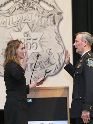 Chief of Police Edward Flynn takes the oath of office during a ceremony at the Milwaukee Safety Academy in 2-16 for his third four-year term as Milwaukee's Chief of Police.  The oath of office was given to him by Milwaukee Fire and Police Commission, Executive Director MaryNell Regan (left).
