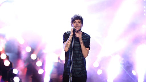 FILE - In this Nov. 22, 2015 file photo, Louis Tomlinson of One Direction performs at the American Music Awards at the Microsoft Theater on in Los Angeles. Tomlinson has been arrested for allegedly attacking a photographer at Los Angeles International Airport, an incident the singer’s lawyer described as “provoked” by paparazzi. The incident happened Friday, March 3, 2017,  after Tomlinson, arriving on a flight with his girlfriend, Eleanor Calder, asked a photographer to stop filming.