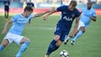 A Man City defender tries to get the ball from Tottenham