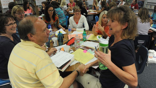 Brown Elementary School second-grade teachers Ron Zoratti and Denise Kolton shake in agreement as they and their co-teachers discuss Common Core State Standards and SEL (social and emotional learning) practices for the upcoming year during training in August.