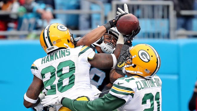 Green Bay Packers cornerback Josh Hawkins (28) and free safety Ha Ha Clinton-Dix (21) try to break up a pass to Carolina Panthers wide receiver Damiere Byrd (18) on Sunday, December 17, 2017 at Bank of America Stadium in Charlotte, N.C.