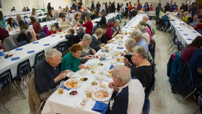 Hundreds of people eat dinner during the Holy Name Feast Day at Holy Name of Jesus Catholic School in Henderson,  Saturday, Jan. 7, 2017. The annual feast commemorates the naming of Jesus Christ. 