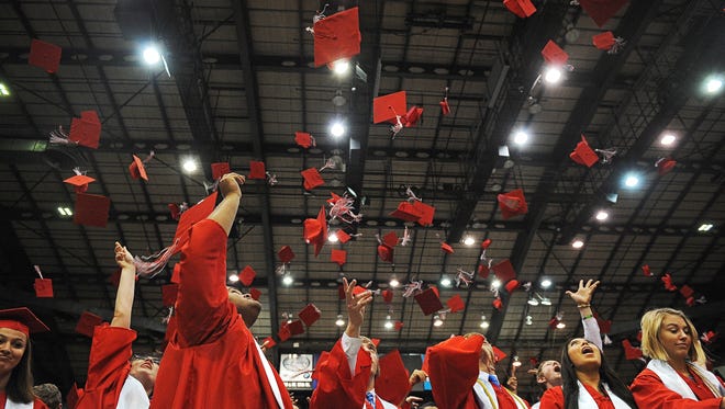 Lincoln High School graduates throw their caps in the air at the end of the Lincoln High School commencement ceremony in 2016.