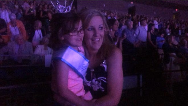Ema and Chara McLaughen smile at Miss Tennessee 2014 Hayley Lewis during night two of the 2015 Miss Tennessee Scholarship Pageant Thursday night.