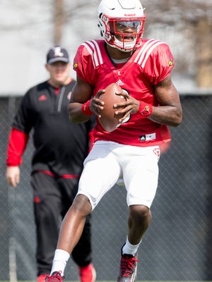 Louisville Cardinals quarterback Lamar Jackson runs with the ball during the UofL Football Open Practice session.