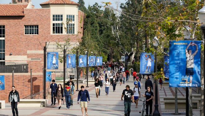 Students walk on the UCLA campus in Los Angeles. The university's Interfraternity Council's Presidents' Council placed an indefinite ban on events involving alcohol at IFC facilities.