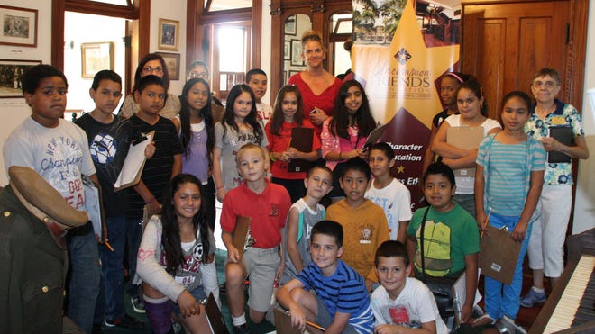 Edgewood Academy students toured the Burroughs Home with Lois Hartel, Uncommon Friends Foundation docent, right.