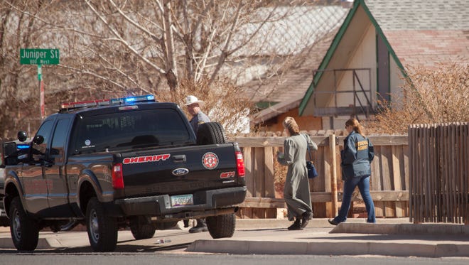 Agents from the FBI and other law enforcement make arrests and collect evidence in Hildale Tuesday, Feb. 23, 2016.