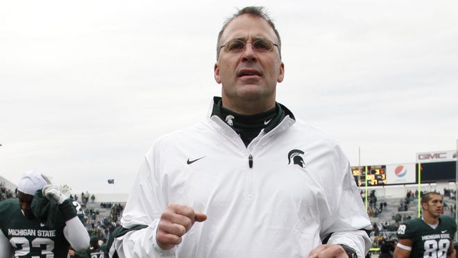 Michigan State defensive coordinator Pat Narduzzi jogs off the field following a win over Indiana on  Nov. 19, 2011.