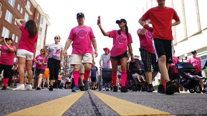 Participants walk toward the finish line on South High Street at the 27th annual Komen Columbus Race for the Cure in 2019. This year's event will be virtual because of the pandemic.