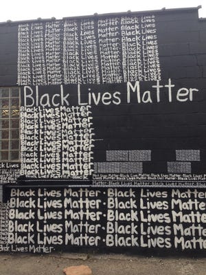 Renda Writer, a white muralist from Miami, painted "Black Lives Matter" repeatedly on the exterior wall behind the N'Namdi Center for Contemporary Art earlier this month to express his support for the "Black Lives Matter" movement.
