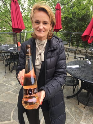 Aurélie Bertin, owner and manager of Chateau Sainte Roseline, holds a bottle of Lamp de Meduse rosé wine.