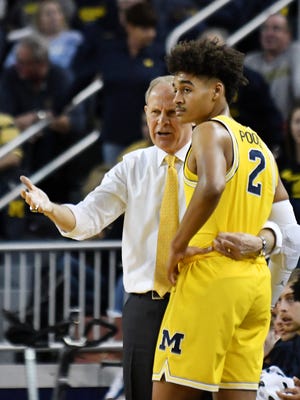 Michigan head coach John Beilein, here talking with guard Jordan Poole (2), will renew acquaintances with former assistant Bacari Alexander and former player Kameron Chatman when the Wolverines face Detroit Mercy on Saturday.