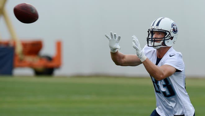The Titans’ Marc Mariani catches a pass Monday during organized team activities. Mariani, who made his mark as a returner, hopes to show he can play receiver just as well.