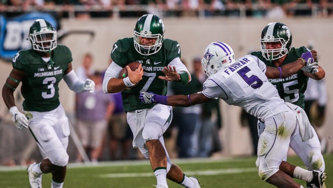 Michigan State Spartans quarterback Tyler O'Connor runs the ball against the Furman Paladins during the opener at Spartan Stadium in East Lansing, Michigan, on Friday, September 2, 2016.