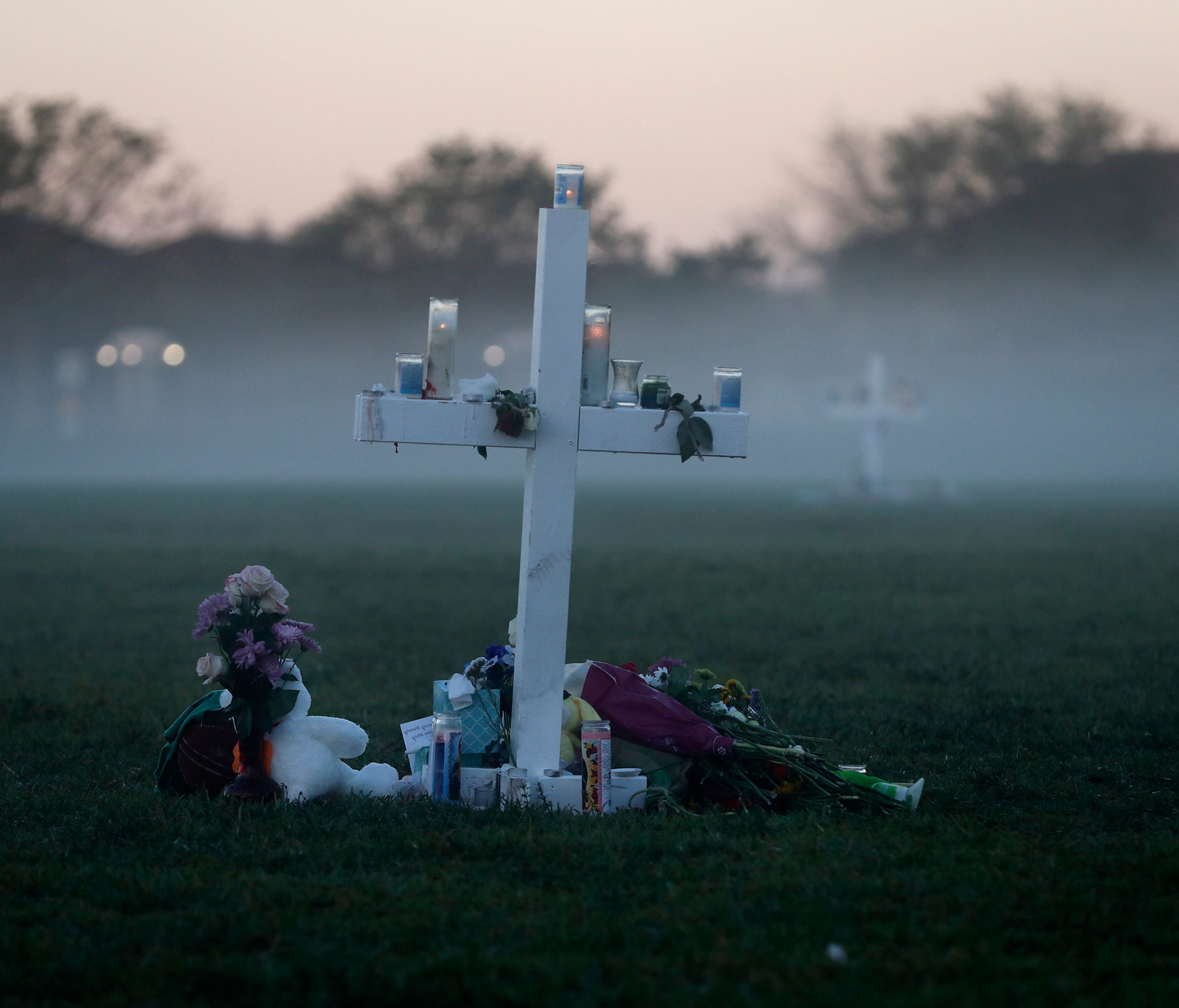 An early morning fog rises where 17 memorial crosses were placed for the 17 deceased students and faculty from the Wednesday shooting at Marjory Stoneman Douglas High School, in Parkland, Fla.