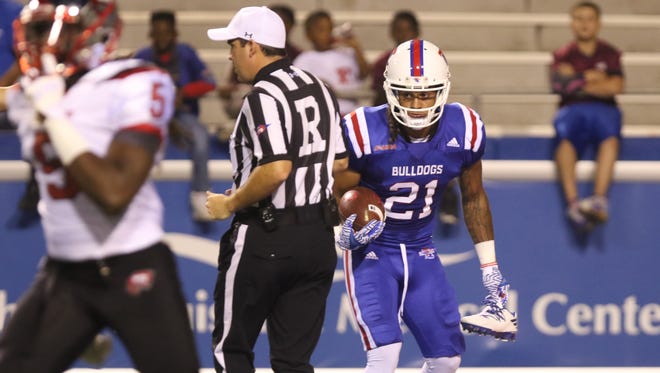 Louisiana Tech wide receiver Alfred Smith picks up a shoe that fell off during the first play of a home game against Western Kentucky on Thursday, October 6, 2016. 