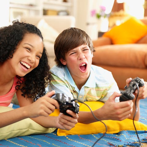 Two children playing console games.