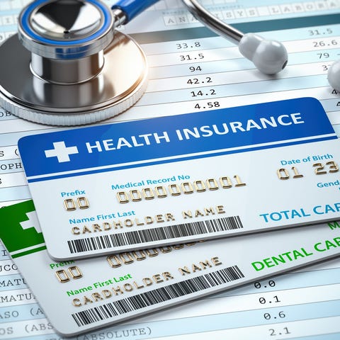 Health insurance cards and a stethoscope on test r