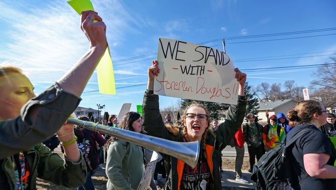 Dubuque Hempstead High School students exit the school during a gun violence protest March 14. Students across the country participated in walkouts to protest gun violence.