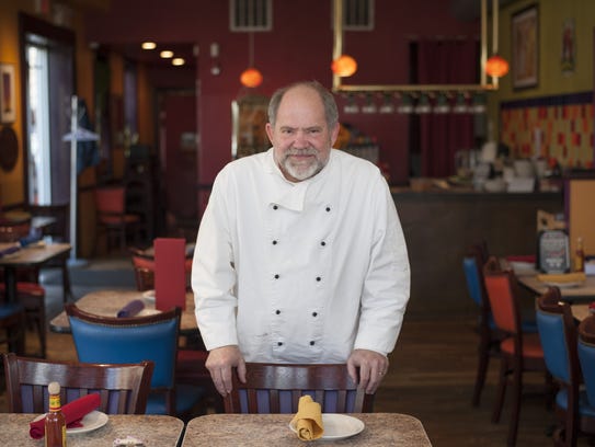 Chef Mark Smith stands in the dining room at his restaurant,