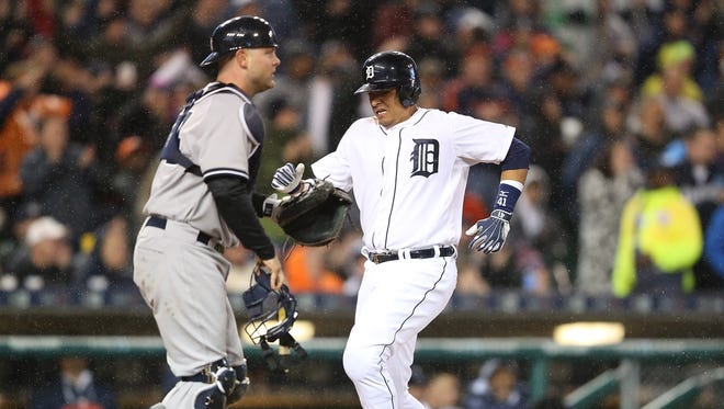 Designated hitter Victor Martinez of the Detroit Tigers scores the winning run against the New York Yankees at Comerica Park on April 20, 2015, in Detroit.