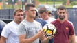 Michigan quarterback John O'Korn holds a soccer ball