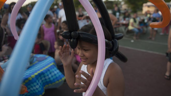Vianna Spinal walks around with a balloon hat at Von Nieda Park in a 2014 photo.
