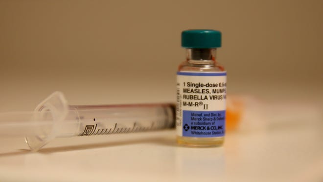 A file photo shows a bottle containing a measles vaccine.