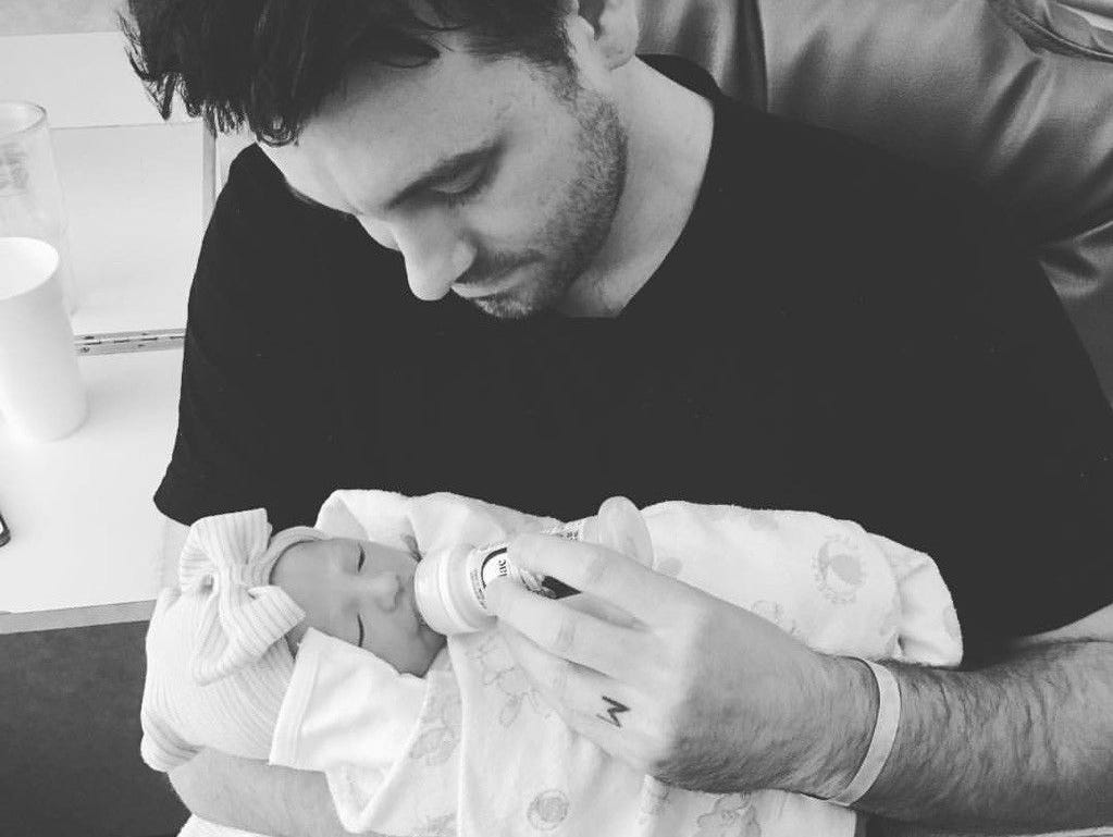 Christian music guitarist Nathan Johnson holds his newborn daughter Eilee. Johnson's wife, Megan, died Tuesday, June 27 from complications after child birth.