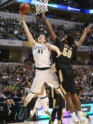 Michigan State's Colby Wollenman scores against Purdue's Caleb Swanigan during the first half Sunday in I