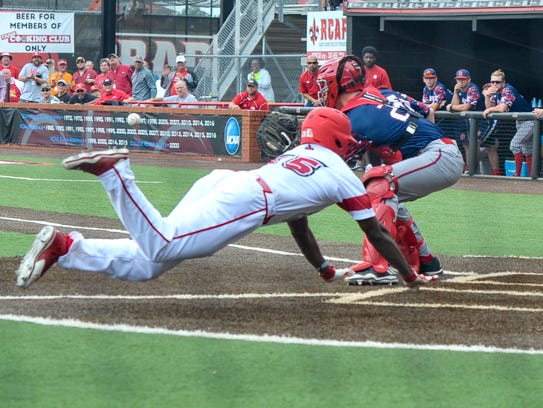 Ishmael Edwards dives for home and beats the throw