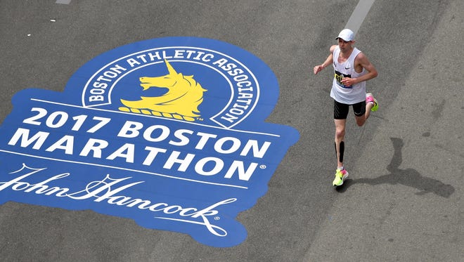 Galen Rupp runs down Boylston Street towards the finish line of the 2017 Boston Marathon.