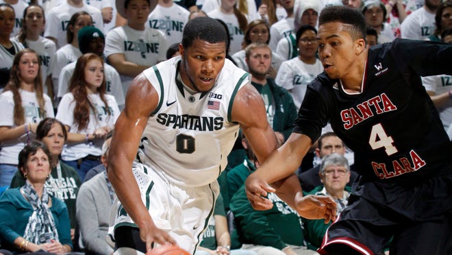 Michigan State's Marvin Clark Jr. (0) drives against Santa Clara's Jarvis Pugh (4) during the first half of an NCAA college basketball game, Monday, Nov. 24, 2014, in East Lansing, Mich. Michigan State won 79-52.