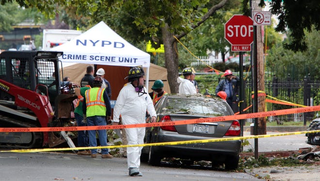 Members of the New York Police Department investigate the scene Sept. 28, 2016, the day after the explosion in the Bronx killed battalion chief Michael Fahy.