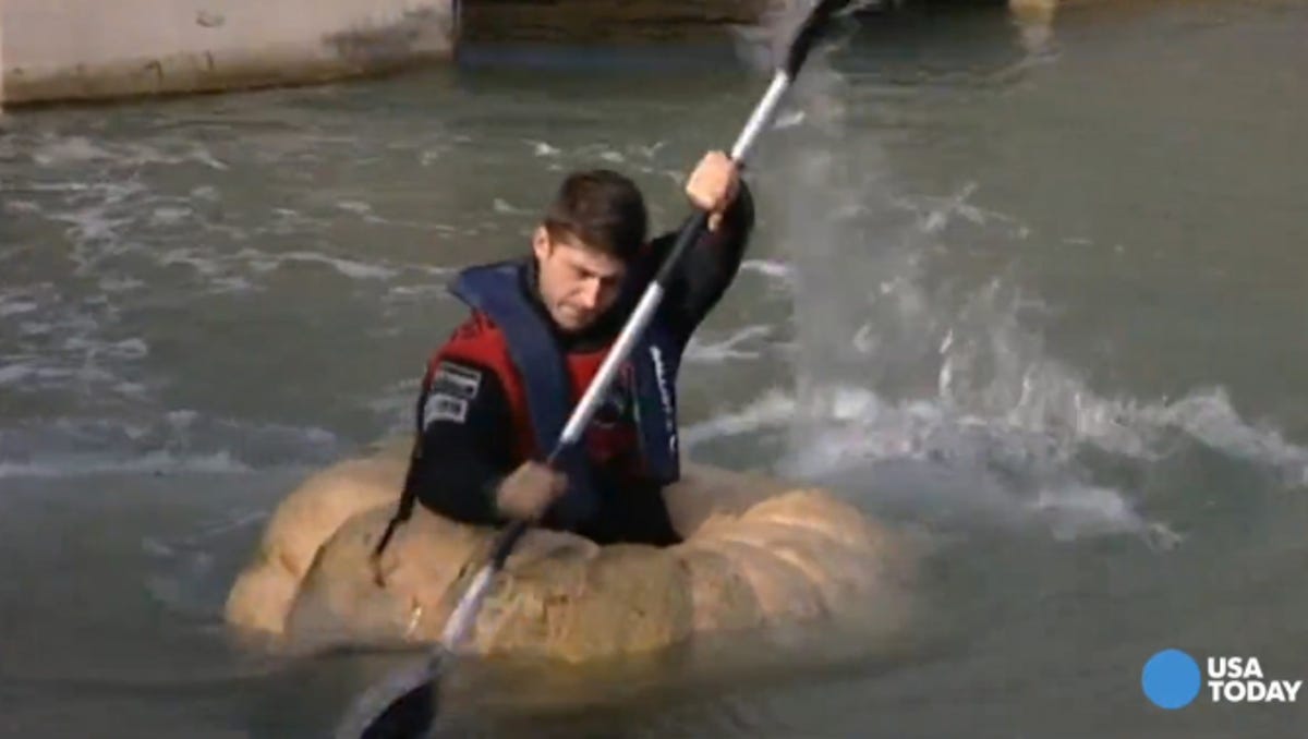 Man Paddles Giant Pumpkin Boat For World Record Man breaks two world records in pumpkin boat. man paddles giant pumpkin boat for