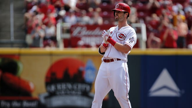 Cincinnati Reds outfielder Jesse Winker reacts after hitting a two-run double in the sixth inning.