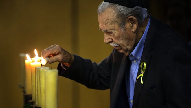 Holocaust Survivor Samuel Kessel lights a candle after sharing his experience during World War II. The El Paso Holocaust Museum and Study Center hosted Yom HaShoah, or Holocaust Days of Remembrance, at Congregation B’Nai Zion. 