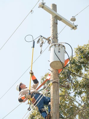 Apprentice line technician Tyler Barry  disconnects the riser leading to the transformer during an exercise at the Gulf Power training facility in Pensacola on Sept. 23.
