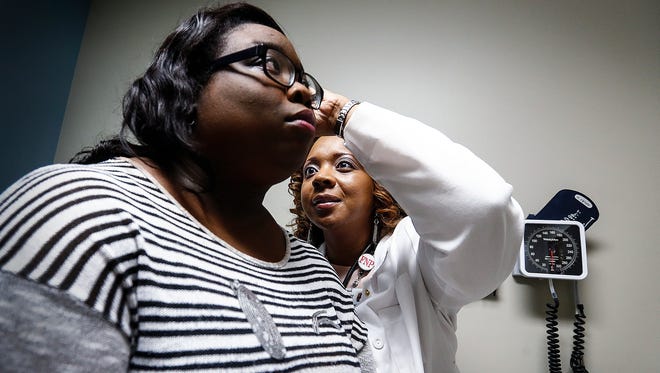 Cherokee Health Systems patient Kadesa Wilson, left, sits for a routine checkup with nurse practitioner Stephanie Smith, (right) during her visit Friday morning. Cherokee Health Systems recently took over operations of Resurrection Health clinics in Memphis.