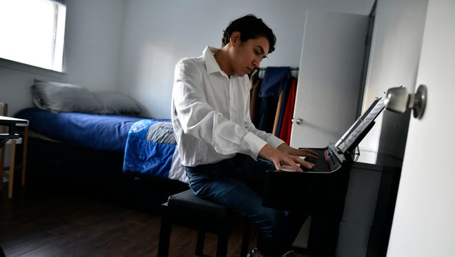 DACA recipient Francisco Bautista, 26, plays his piano after a day of work at his home Friday afternoon, March 2, 2018 in Dallas. Bautista has been taking piano lessons recently. (Ben Torres/Dallas Morning News/TNS) NO MAGAZINE SALES MANDATORY CREDIT; NO SALES; INTERNET USE BY TNS CONTRIBUTORS ONLY