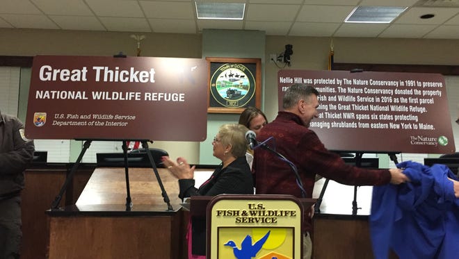 Dover town Supervisor Linda French, center, applauds at the unveiling of signs marking the Great Thicket National Wildlife Refuge at a ceremony at town hall on Wednesday, Jan.18 2017. Nellie Hill Preserve in Dover Plains was donated by the The Nature Conservancy to the U.S. Fish & Wildlife Service to establish the nation's 566th national wildlife refuge. At right is Tony Wilkinson, director of the state Department of Environmental Conservation's Division of Fish and Wildlife.