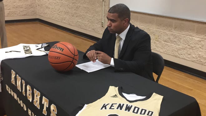 Kenwood's new boys basketball coach Jason James sits while being introduced as the school's new coach Friday at Kenwood High School.
