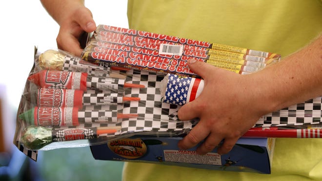 Before launching a neighborhood fireworks show, officials say you should make sure you're not breaking any laws and that you're using the explosive devices safely. (Associated Press photo)