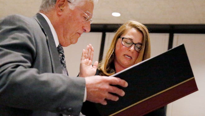Corning Mayor Rich Negri swears in Republican Michelle Beckman Monday into the Second Ward seat on the city council. Beckman won the seat in a 5-3 vote against Democrat Kate Paterson.