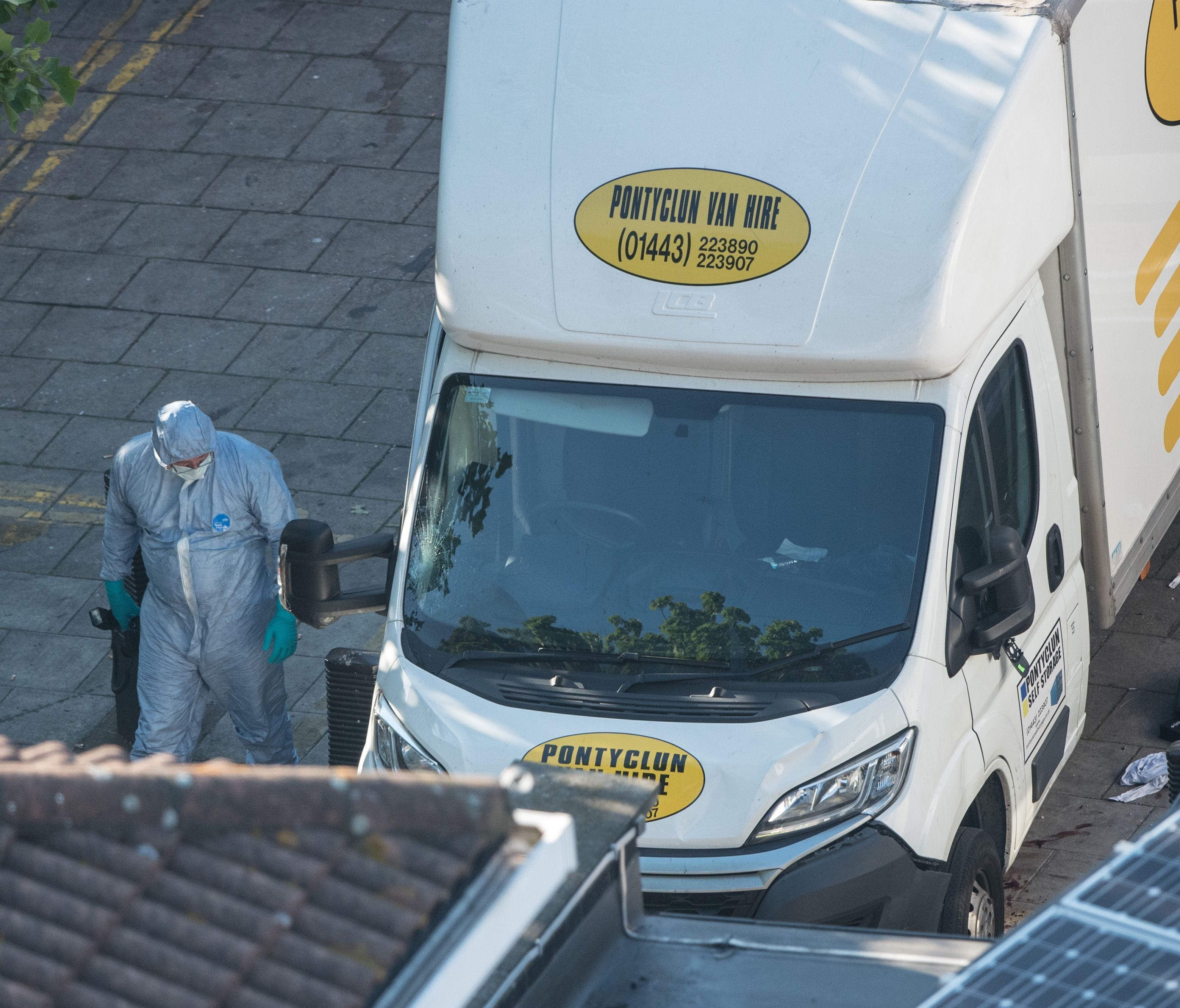 A police forensics officer examines a van believed to be involved in an incident near Finsbury Park Mosque in which one man was killed after a vehicle plowed into pedestrians early Monday.